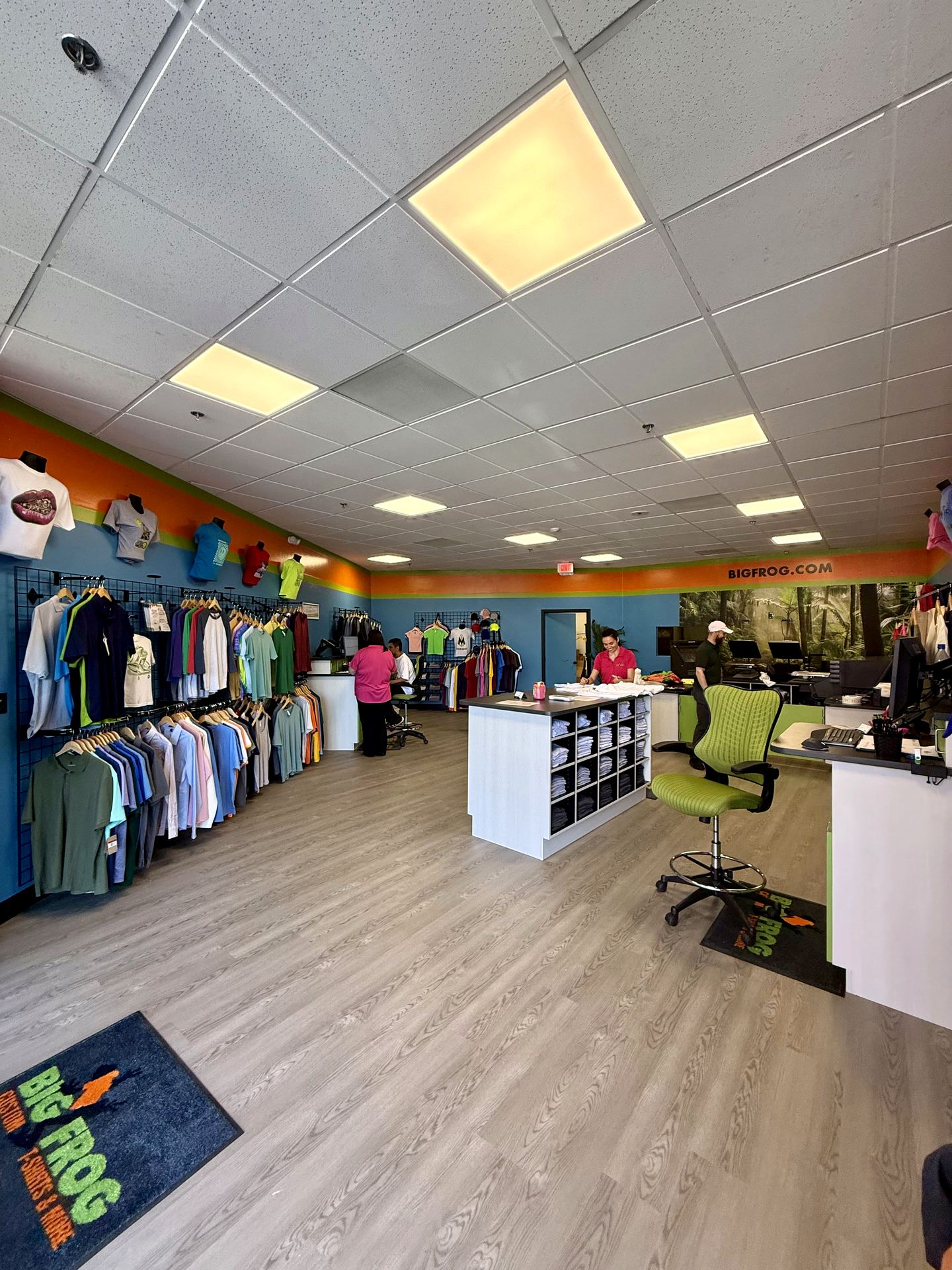 Finished Big Frog retail floor with merchandising walls, product island, and new flooring, Santa Monica store buildout by ASEP Contractors