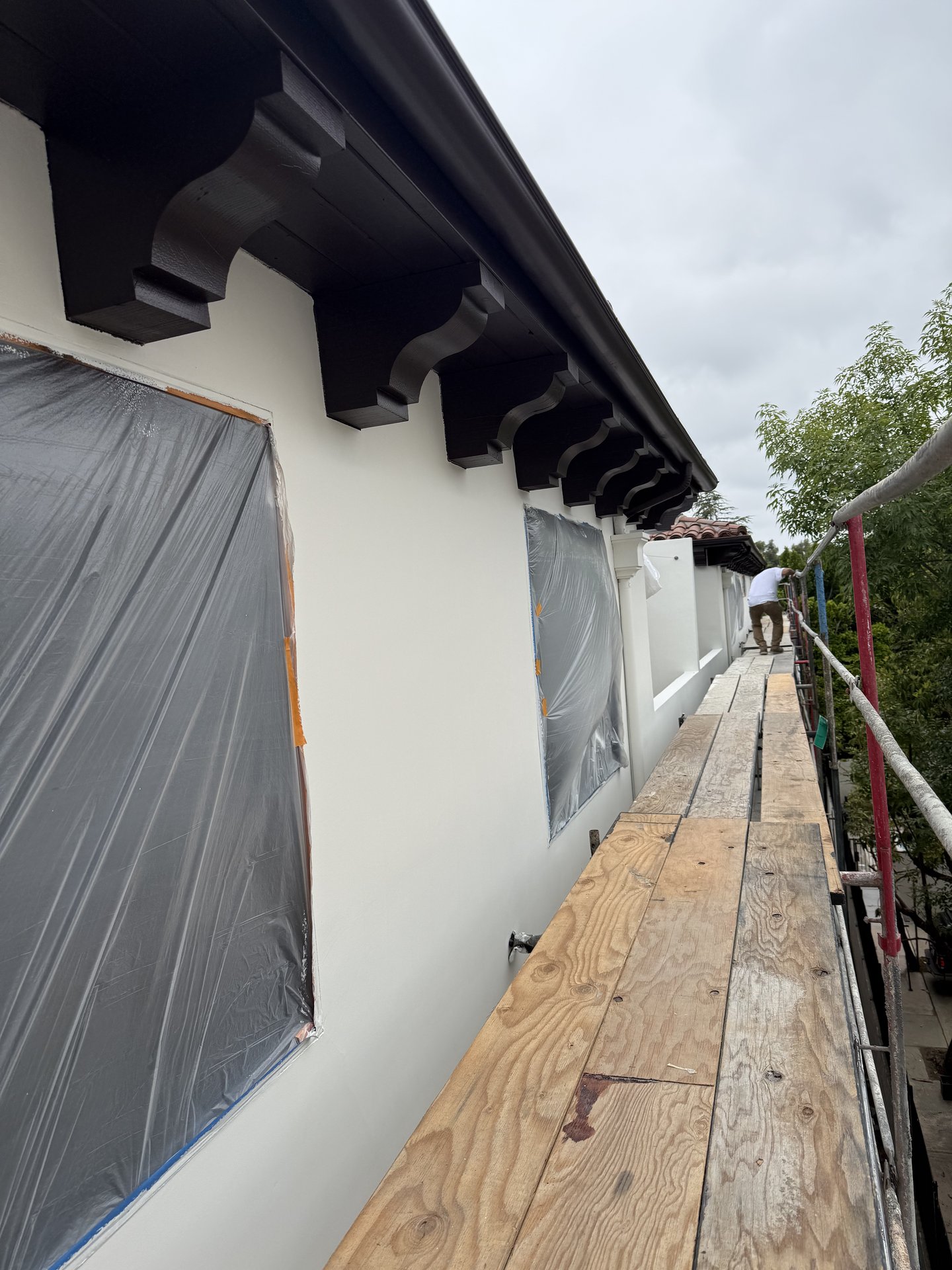 Repainted Spanish-style eave corbels and exterior trim work at height